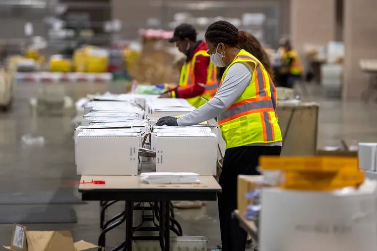 Philadelphia elections workers prepare for the sorting and counting of mail ballots at the Pennsylvania Convention Center.