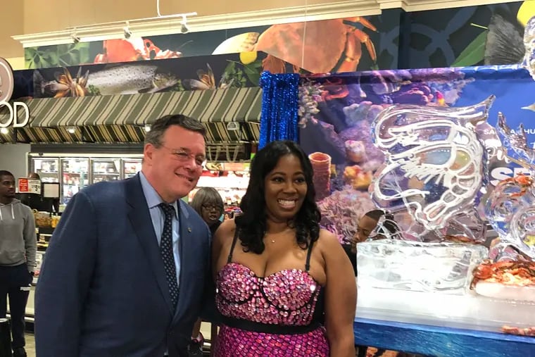 Jeff Brown, founder and owner of Brown Super Stores, poses with Saudia Shuler, also known as the Camel Prom Mom, in June to celebrate the addition of Country Cookin Seafood Salad at the Fox Street Shoprite.