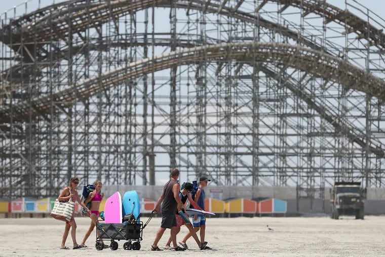 A group leaves the beach with all of their gear in Wildwood, N.J. on Sunday, July 17, 2022.