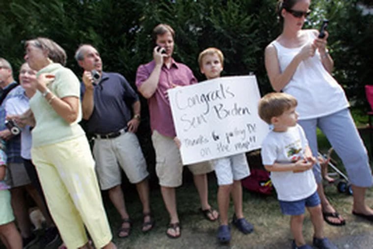 Michael Hutts, 8, holds a sign of congratulations as he and his family wait to greet Biden outside the senator&#0039;s house. &quot;It&#0039;sbig news for Delaware,&quot; said Michael&#0039;s mother, Beth (right).