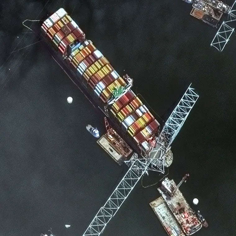 This satellite image provided by Maxar shows the bow of the container ship Dali remains stuck underneath sections of the fallen Francis Scott Key Bridge, while salvage crews and barges with cranes continue removing some of the bridge debris and hundreds of shipping containers still onboard the vessel, in Baltimore, last week.