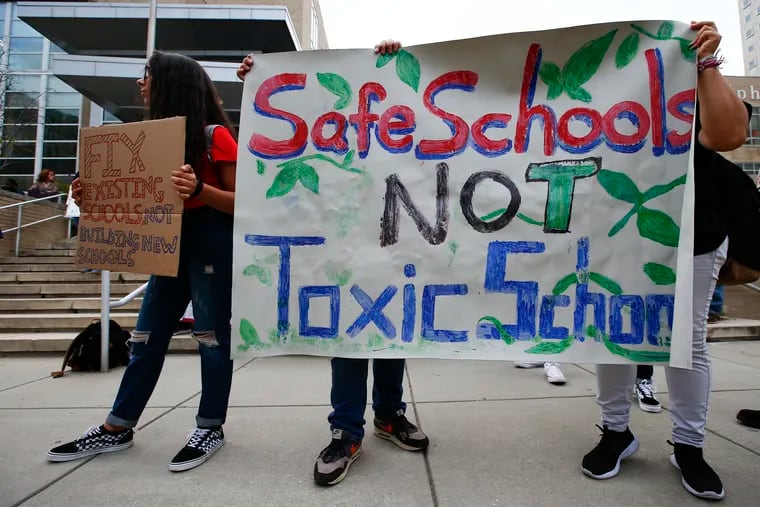 Students hold signs during a rally before the School District of Philadelphia conducted a town hall meeting discussing the temporarily relocating of Ben Franklin and SLA students while construction is completed on the new shared campus.