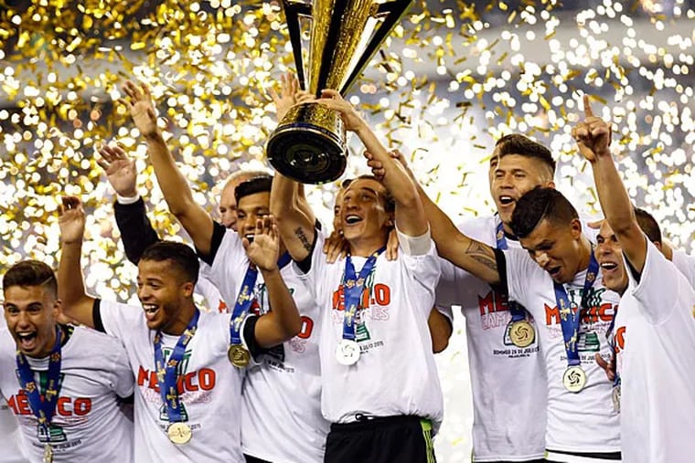The Mexican men's soccer team celebrates their CONCACAF 2015 Gold Cup win. (Yong Kim/Staff Photographer)