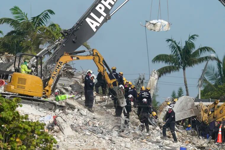 Rescue crews work at the site of the collapsed Champlain Towers South condo building after the remaining structure was demolished Sunday, in Surfside, Fla., Monday, July 5, 2021. Attorneys for the families who lost relatives or homes in last year’s collapse of a Florida condominium tower that killed 98 people finalized a $1 billion settlement on Friday, May 27, 2022.