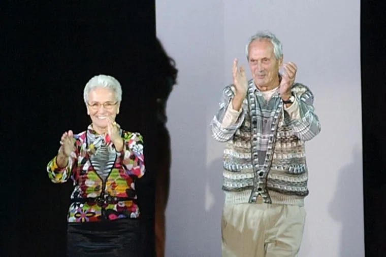 FILE - In this Oct. 2003 file photo Rosita, left, and Ottavio Missoni take the catwalk after presenting their Spring/Summer 2004 fashion collection, in Milan, Italy. Italian fashion company Missoni says its co-founder, Ottavio Missoni, has died in his home earlier on Thursday, May 9, 2013 in northern Italy. Missoni, who was 92, founded the iconic fashion brand of zigzagged-patterned knitwear along with his wife, Rosita, in 1953. The Missonis are a family fashion dynasty, with the coupleís children and their offspring involved in expanding the brand. (AP Photo/Antonio Calanni, File)