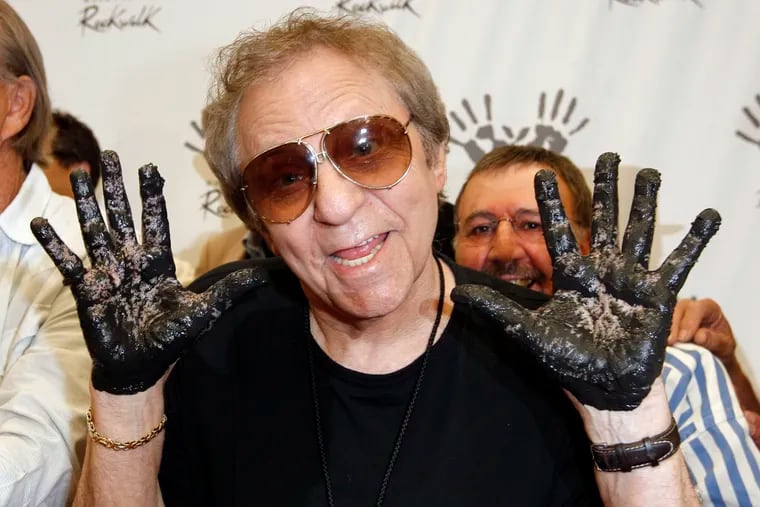 FILE - In this June 25, 2008, file photo, Hal Blaine holds up his hands covered in cement after placing them in wet cement with Don Randi and Glen Campbell, representing the Wrecking Crew following an induction ceremony for Hollywood's RockWalk in Los Angeles. Drummer Blaine, who played on many of the biggest hits in music history, has died. Blaine's son-in-law Andy Johnson tells the Associated Press that Blaine died of natural causes Monday, March 11, 2019, at his home in Palm Desert, Calif. He was 90.