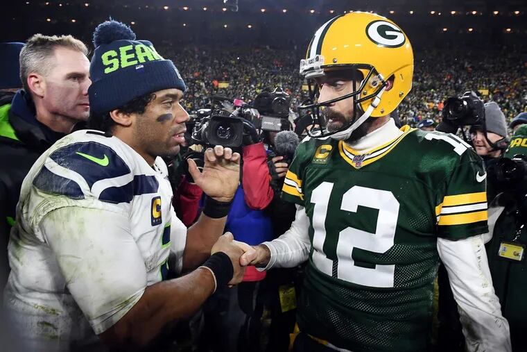 Russell Wilson (left) is headed from Seattle to Denver, while Aaron Rodgers stays in Green Bay.