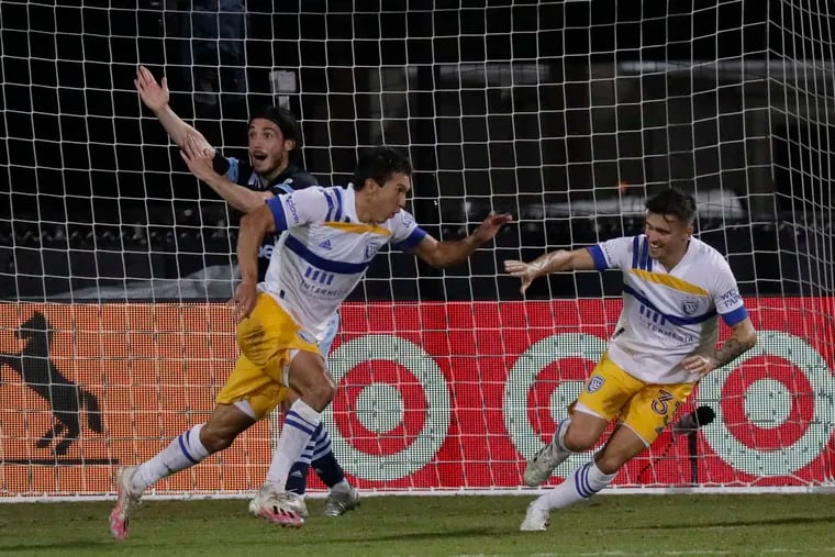 San Jose Earthquakes midfielder Shea Salinas (left) celebrates his game-winning goal with defender Paul Marie (Right).