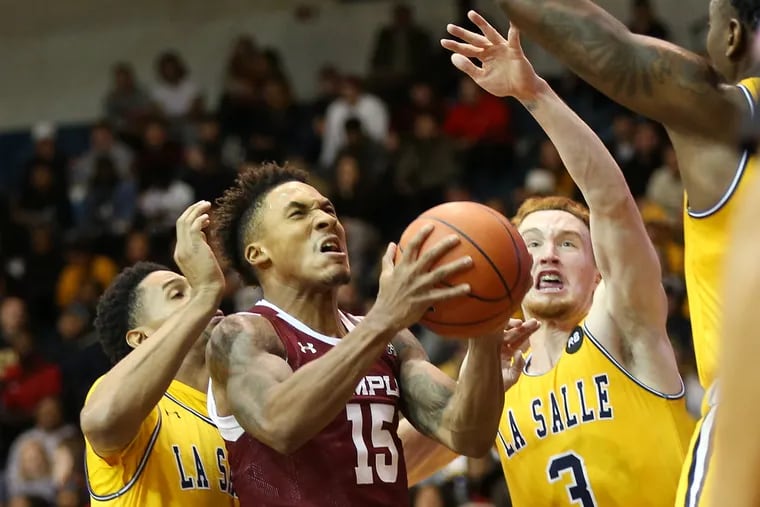 Temple guard Nate Pierre-Louis (15) goes for a layup past La Salle guards Scott Spencer (2) and Christian Ray (3) during a game at Tom Gola Arena in North Philadelphia on Saturday, Nov. 16, 2019.