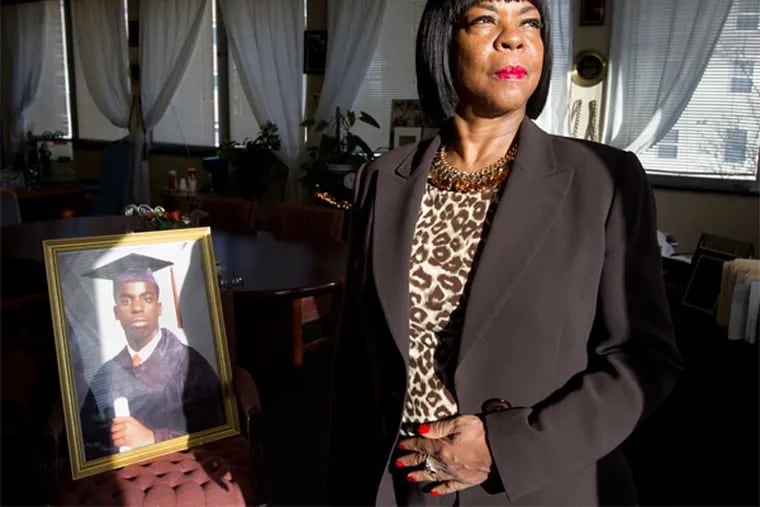 Dorothy Johnson-Speight, Executive Director of the antiviolence group Mothers In Charge, is the Inquirer's Citizen of the Year. In the background, left, is a portrait of her son Khaaliq Johnson. ( CHARLES FOX / Staff Photographer )