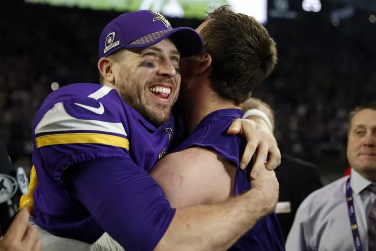 Minnesota Vikings quarterback Case Keenum, left, celebrates after a 29-24 win over the New Orleans Saints during the second half of an NFL divisional football playoff game in Minneapolis, Sunday, Jan. 14, 2018. (AP Photo/Jeff Roberson)