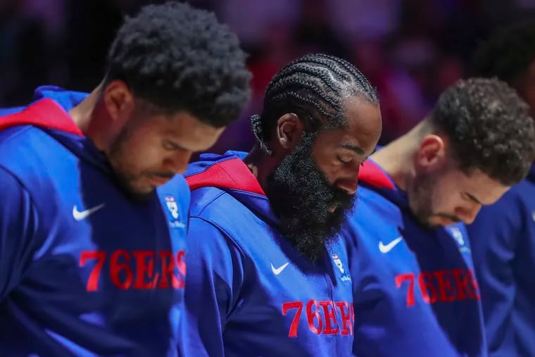 From left, Tobias Harris and James Harden standing for the national anthem before a game against the San Antonio Spurs at the Wells Fargo Center in Philadelphia on Oct. 22, 2022.
