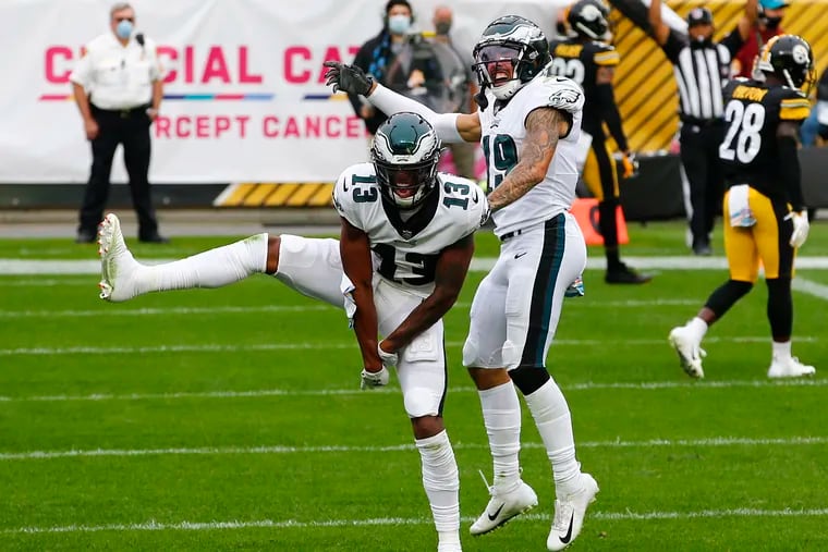 Eagles wide receiver Travis Fulgham (left) celebrates his fourth-quarter touchdown with teammate J.J. Arcega-Whiteside against the Steelers on Sunday.