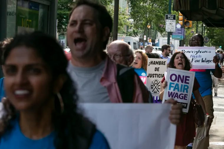 People march to El Fuego restaurant in Center City to raise attention to a possible federal and state minimum wage raise on Friday, July 12, 2019.