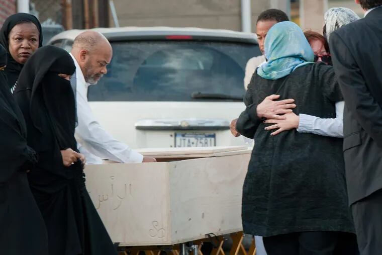 Family, friends and parishioners gather around Nathan Ackison's casket Thursday outside the Masjid al Madinah mosque in Upper Darby to pay respects to the victim of a fatal stabbing rampage Tuesday.