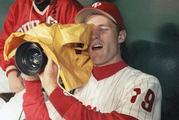 Former Phillie Kevin Stocker plays around with a television camera during a rain delay before the start of Game 3 of the 1993 World Series.