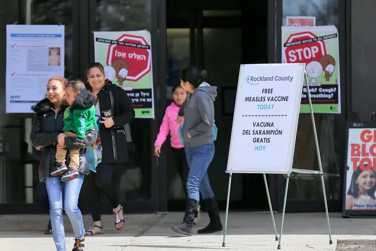 Signs advertising free measles vaccines and information about measles at the Rockland County Health Department, in Pomona, N.Y.