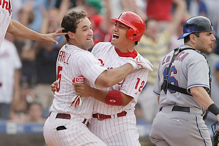 Tadahito Iguchi is mobbed by Pat Burrell after Iguchi scored the winning to clinch the NL East in 2007. (Ron Cortes/Staff Photographer)