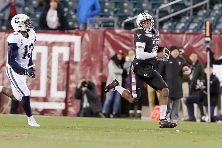 Temple quarterback Todd Centeio looks back at UConn's Messiah Turner as he runs for a big gain in the second quarter Saturday.