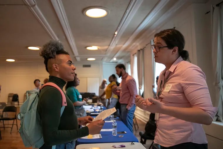 Celeste Divinity, left, speaks with Brenda Klitsch, an attorney with the Mazzoni Center, at a job fair for transgender and nonbinary people hosted at the William Way Community Center in Center City. TransWork and the Philadelphia International Airport hosted the fair.