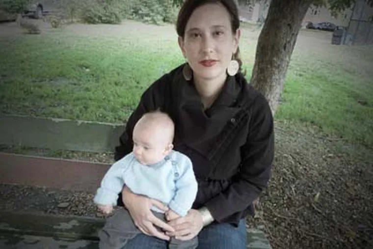 Kate Clark holds her son, August, who was born June 10, 2011, as they sat last year in Columbus Square Park, at 12th and Wharton streets in South Philly, near her home. August is one of the new Philadelphians who contributed to the city's estimated white population growth since the 2010 Census.