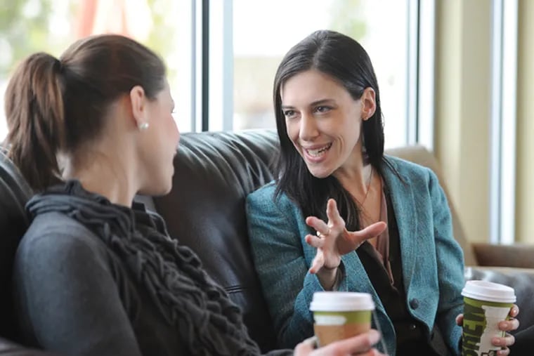 DailyWorth founder and CEO Amanda Steinberg (right) talks with client Niki Brennan, who says Steinberg’s advice has been important to her success in launching a makeup business. (Clem Murray / Staff Photographer)