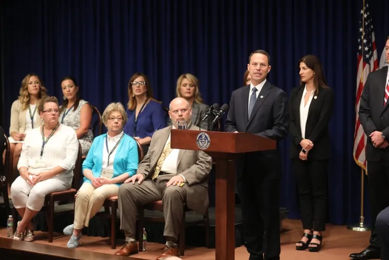 Unidentified victims and families and sexual abuse victims sit on the stage as Pennsylvania Attorney General Josh Shapiro releases the findings of a two-year grand jury investigation into clergy abuse at six of the stateÕs Roman Catholic Dioceses, leading a news conference at the Capitol in Harrisburg on Aug. 14, 2018. DAVID SWANSON / Staff Photographer