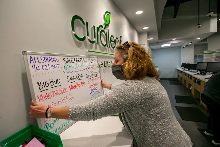 Bridgette Fonseca with the strain board in the dispensary at Curaleaf, cannabis dispensary at 640 Creek Road in Bellmawr, NJ on Wednesday, September 30, 2020. Curaleaf is considered one of the "Big Four" multistate operators.