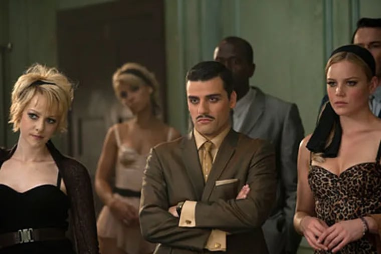 Jena Malone (left), Oscar Isaac, and Abbie Cornish in the epic action fantasy with girl-gang and video-game motifs that quickly get stale.