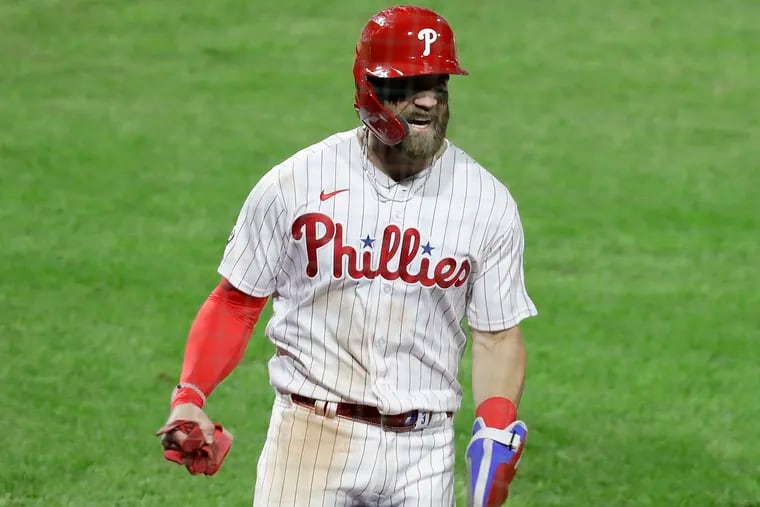 Phillies Bryce Harper yells after scoring in the eighth inning against New York Mets on Monday, April 5, 2021 in Philadelphia.
