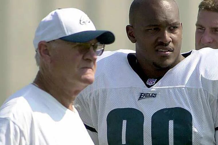 Tommy Brasher reprising his role as the Eagles' defensive line coach. This photo from 2001 shows Brasher standing next to former Eagle Corey Simon. (Brad C Bower/AP file)