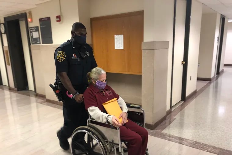 Jacquelyn Walker, 64, is escorted into a courtroom in the Montgomery County Courthouse on Thursday. Walker was sentenced to 12 to 24 years in state prison for a crash that killed a Lower Merion firefighter.