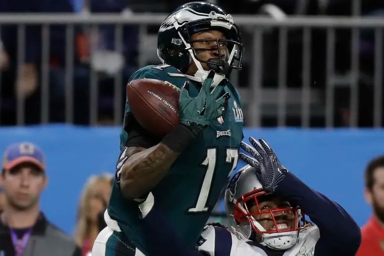 Eagles wide receiver Alshon Jeffery tries to catch the football over his friend and former roommate, New England Patriots cornerback Stephon Gilmore, during Super Bowl LII.