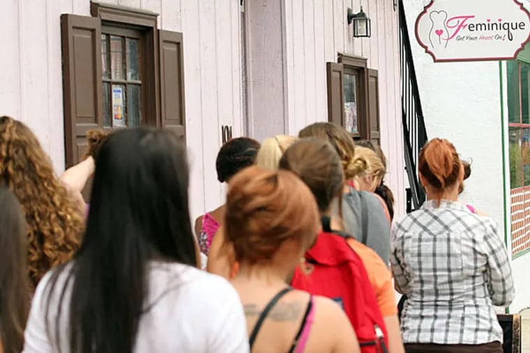 Hundreds of curious customers lined up at the Feminique boutique Sunday to get a free vibrator.