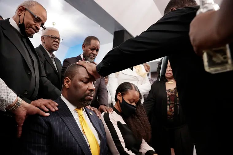 Councilmember Kenyatta Johnson and his wife Dawn Chavous are anointed during the prayer and laying of the hands by Bishop James Robinson during prayer service Friday at Yesha Ministries in South Philadelphia ahead of their federal bribery trial.