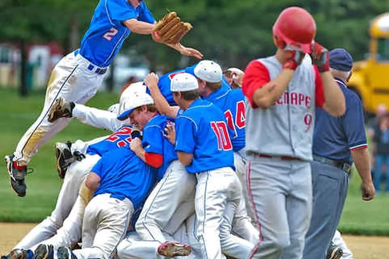 Just can't look: As Washington Township celebrates a 7-4 win in the Group 4 title game, Lenape's Steve Kramitz - who made the final out - pulls his batting helmet down over his eyes.