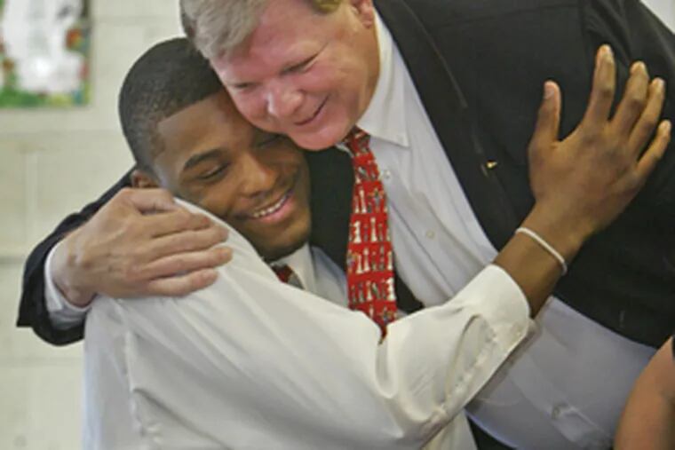 Northeast High&#0039;s Sean Evans embraces his former principal Kelly Barton.