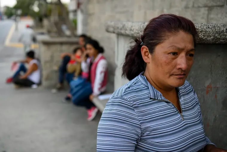 Damarys Perez Carrillo, from Guatemala, waits near the U.S.-Mexico border shortly after being returned to Ciudad Juarez, Mexico, to wait for her hearing in the United States on June 13, 2019.