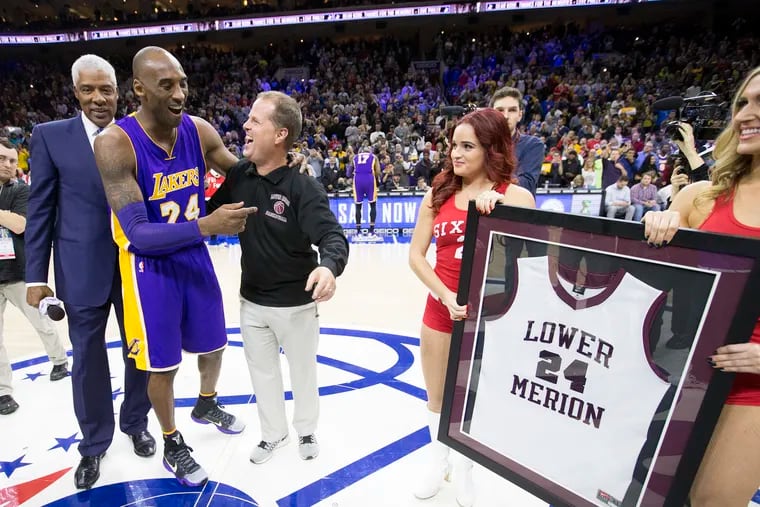 Julius Erving (left) and Gregg Downer (Kobe's high school coach at Lower Merion) present Kobe Bryant with a framed jersey on  Dec. 1, 2015 in Bryant's final game in Philadelphia.
