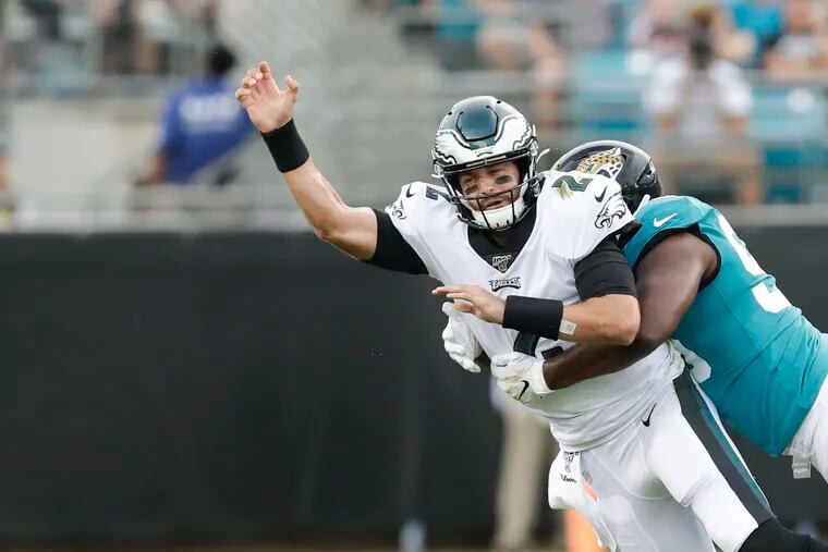 Eagles quarterback Cody Kessler gets rid of the football after getting hit by Jacksonville Jaguars defensive end Datone Jones during the first quarter. Kessler left the game after the hit by Jones.