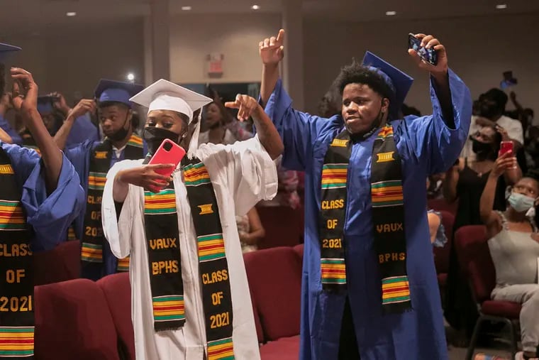 Kyasia Banks and Tymeer Bailey celebrate during their Vaux Big Picture High School graduation ceremony.