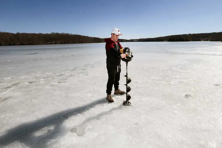 Ryan Czech, 16, from Cheltenham using an auger to drill a eight-inch hole in the ice on Lake Ladore in Wayne County.