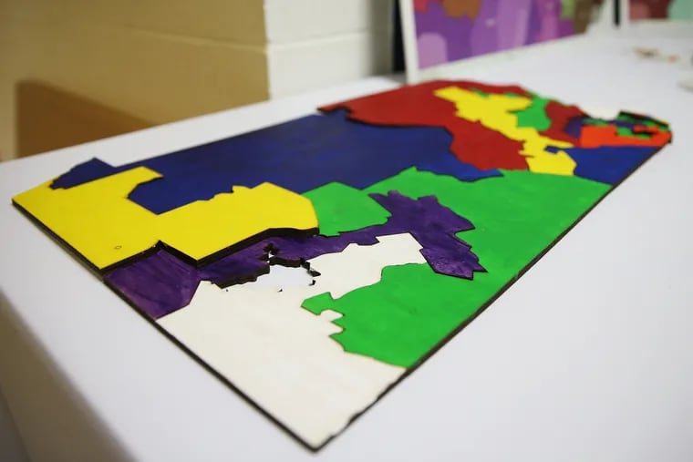 A puzzle of political districts sits on a table during a public input meeting of the Pennsylvania Redistricting Reform Commission at Tindley Temple United Methodist Church in South Philadelphia on Tuesday, May 28, 2019.