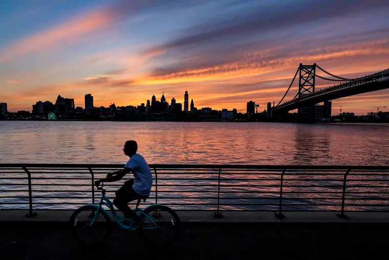 The sun sets behind the Philadelphia skyline as seen from the Camden waterfront on one of the final days of summer.