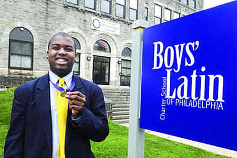 Ameer Purdie, of Boys' Latin of Philadelphia Charter, with the medal he earned for receiving a perfect score on the National Latin Exam. (Sarah J. Glover / Staff)