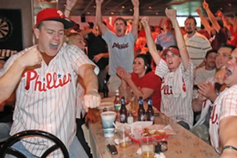Wild with glee, Phillies fans celebrate the pennant at Reale&#0039;s Sports Bar at Cottman and Frankford avenues.