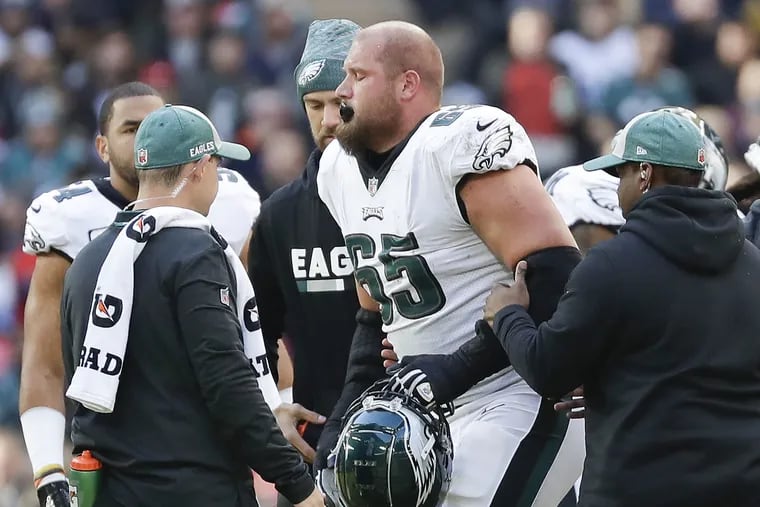 Lane Johnson leaves the field with team medical personal after getting injured in the first quarter on Sunday. It was reported later that he has an MCL sprain.