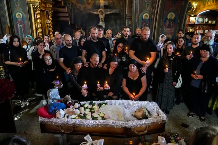 Relatives and friends pay their last respects to Liza Dmytrieva, a 4-year-old girl killed by a Russian attack, during a mourning ceremony in an Orthodox church in Vinnytsia, Ukraine. Liza was among 23 people killed last week in a July 14 missile strike in Vinnytsia.