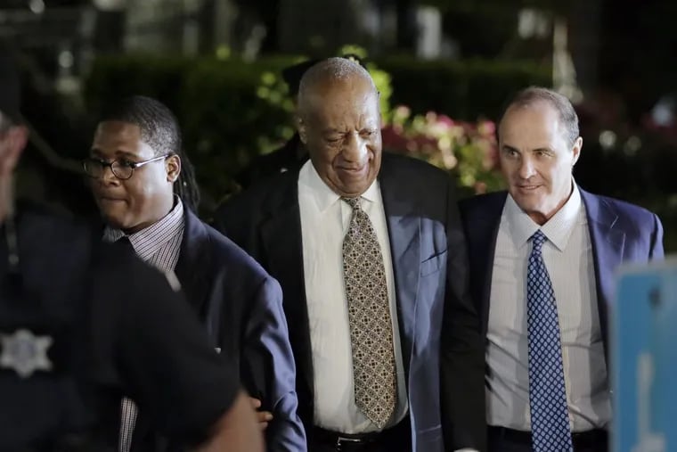 Bill Cosby (center) leaves the Montgomery County Courthouse in Norristown on June 15.