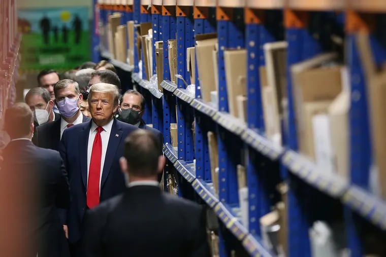 President Donald Trump tours the Owens & Minor medical equipment distribution center in Allentown, Pa., on Thursday, May 14, 2020. The president has called for Pennsylvania to speed the process of reopening businesses after the coronavirus shutdown.